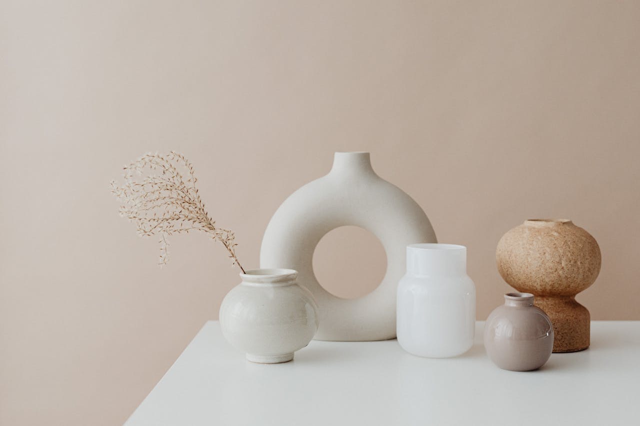 A collection of elegant minimalist ceramic vases on a white surface, perfect for modern home decor.